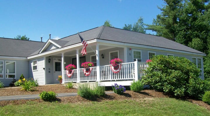 Exterior view of Forestview Manor with flowers and flag