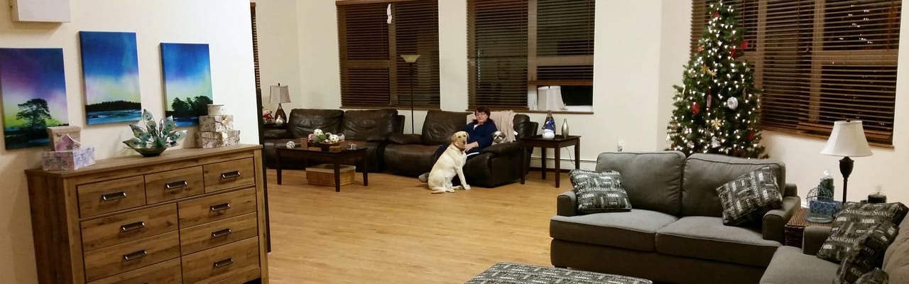 Residents enjoying a cozy common area with a dog