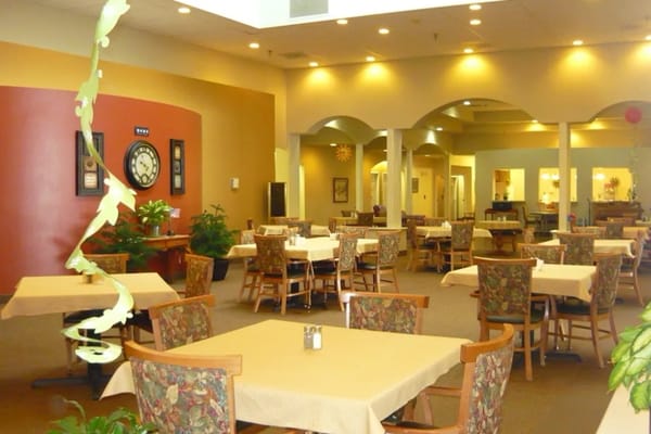 Dining area with tables and chairs in a bright interior