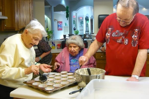 Residents making muffins in the activity room