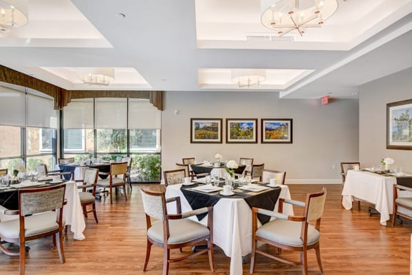 Elegant dining room setup with tables and flowers