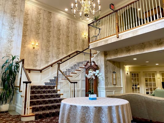 Bright lobby area with staircase and decorative elements