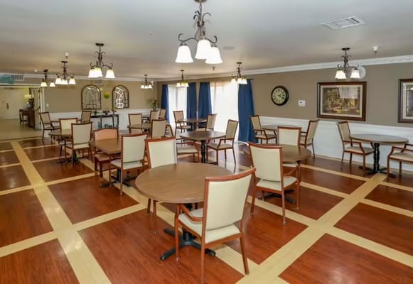 Dining area with tables and chairs in a well-lit room