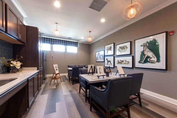 Interior view of a common area with tables and artwork
