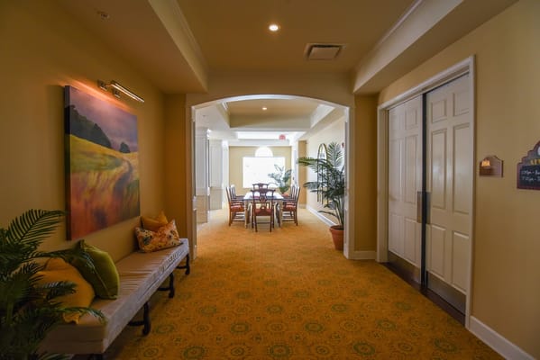 Bright corridor in a senior living facility with seating