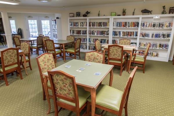 Interior view of a library with wooden tables and bookshelves