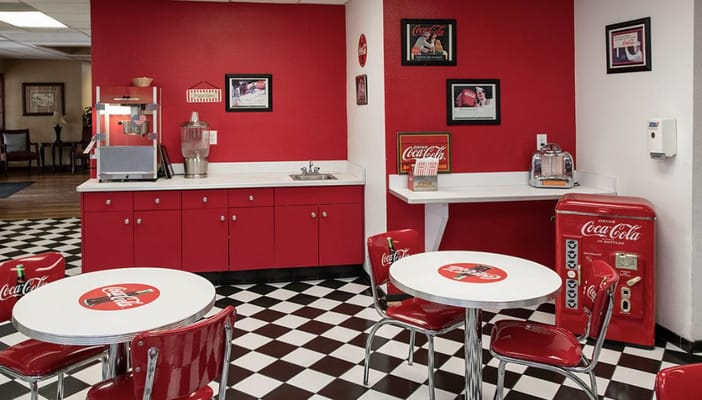 Brightly colored dining area with red walls and Coca-Cola decor