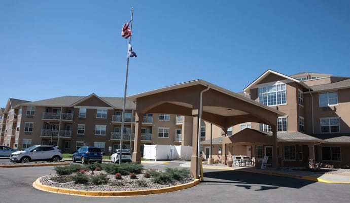 Entrance of Holiday Oxmoor Lodge with covered area and flags
