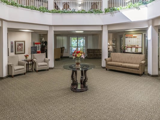 Spacious lobby with seating and decorative flowers