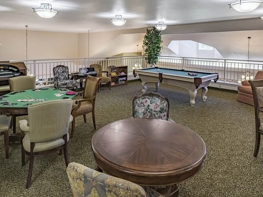 Cozy recreation room with poker table and billiards
