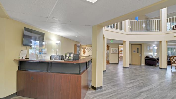 Spacious reception area with a desk and seating