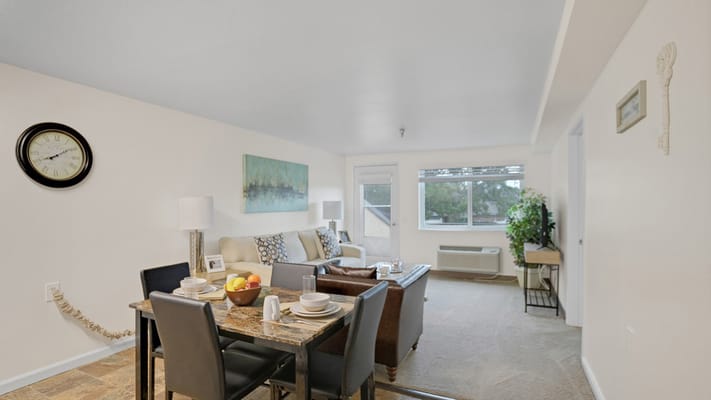 Bright and inviting living room with a dining area and large windows