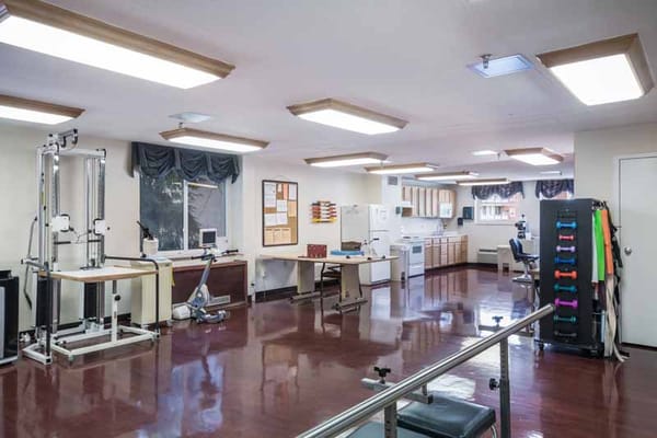 A well-lit therapy room with equipment