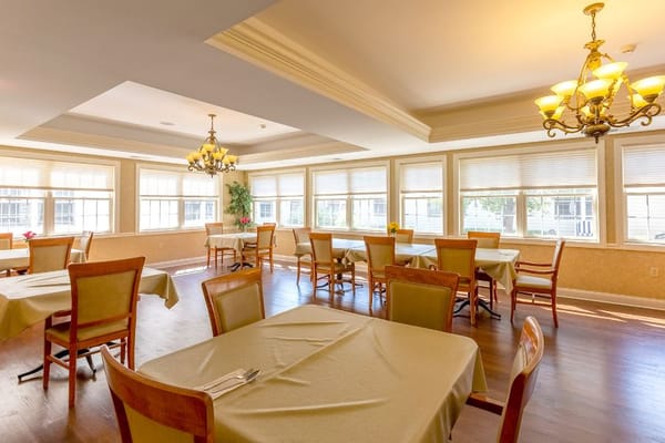 Bright dining room with large windows and tables