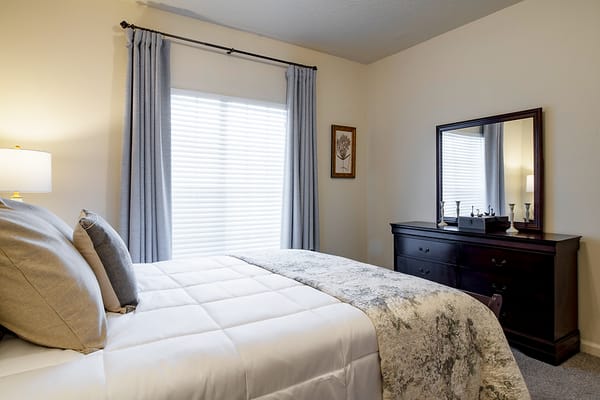 Cozy private resident room with bed and dresser