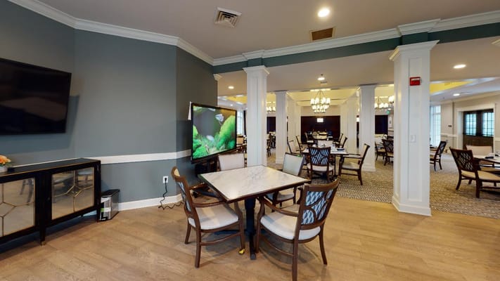 Dining area with tables and chairs in a spacious interior