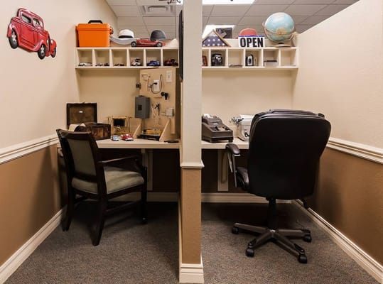A small workspace with two desks and decorative items.