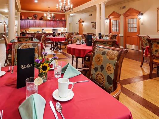Set dining table in a cozy dining room with flowers and menus