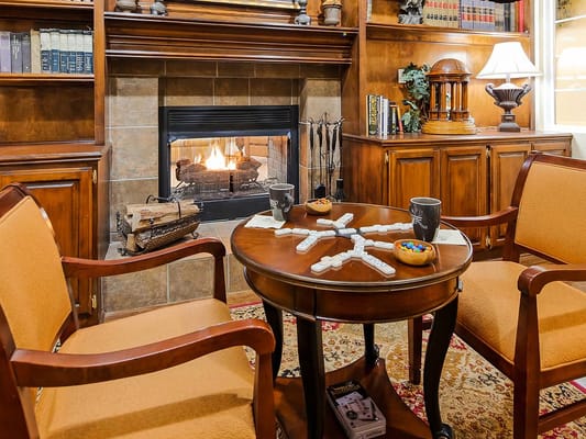 Warm living room with a fireplace and seating area