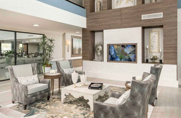 Stylish lounge with comfortable seating and a decorative wall.