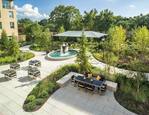 Elegant outdoor garden area with seating and fountain