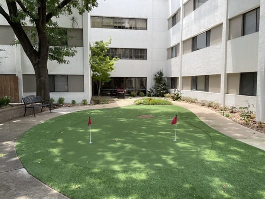 An outdoor putting green in a courtyard