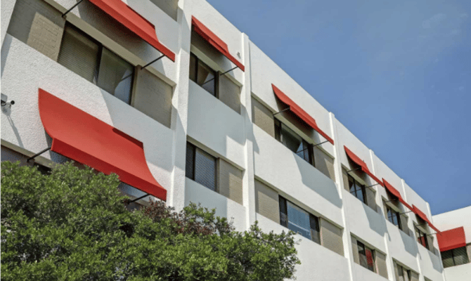 Exterior view of a building with red awnings