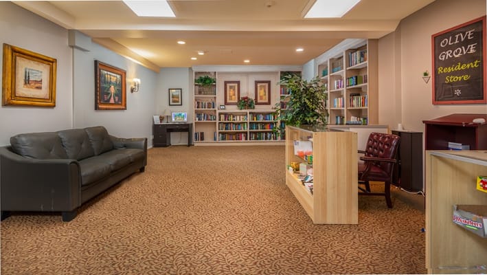 Interior view of the resident store with bookshelves, seating area, and service desk.