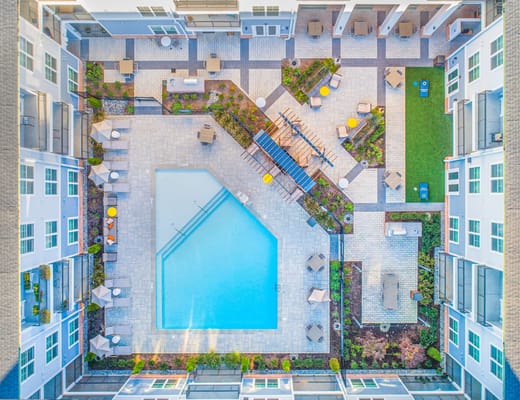 Aerial view of a pool and lounge area in a senior living community