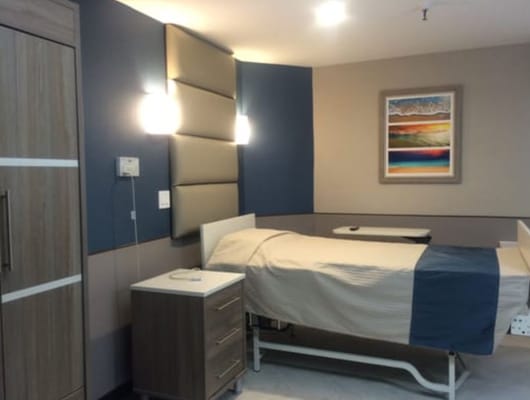 Private resident room with a bed and artwork