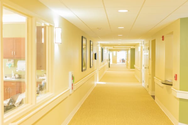 Bright, well-lit hallway in a senior living facility
