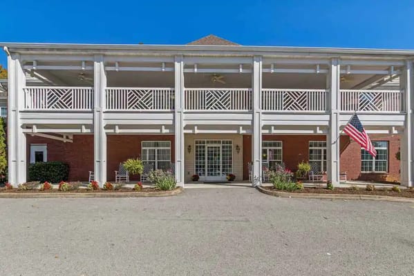 Front view of Park Place of Fountain City with a flag and landscaped entrance