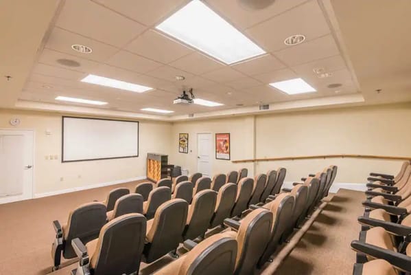 Interior view of the auditorium with seating and projector screen