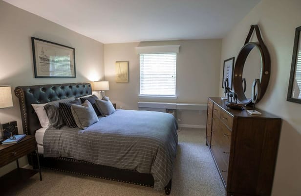 Cozy bedroom with a well-made bed and decor