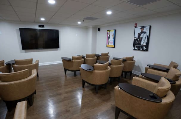 Common area with seating and a large screen