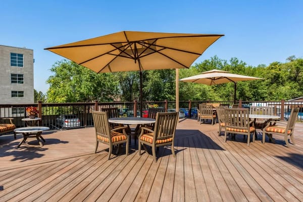 Outdoor deck area with umbrellas and seating