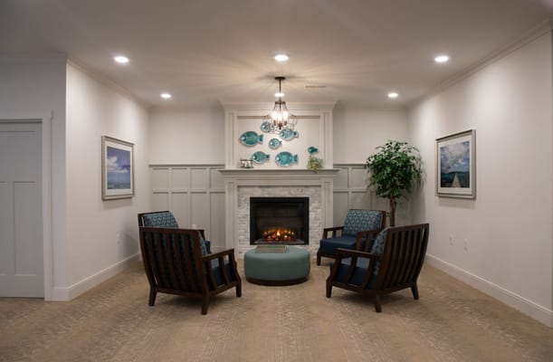 Lounge area with armchairs, fireplace, and decorative wall art
