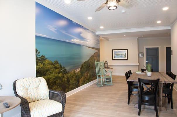 Common area featuring a scenic wall mural of a lakeside view.