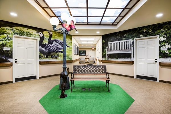 Interior common area with a bench and landscaped walls