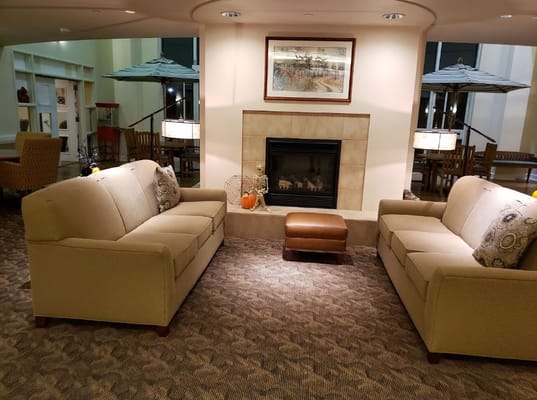 Cozy common area with sofas and a fireplace