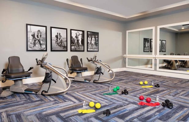 A gym area with exercise bikes and weights at Ridgefield Station.