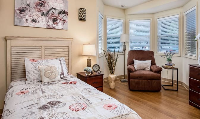 Cozy resident room with a bed and chair