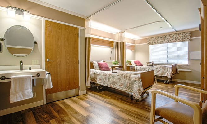 Private resident room with two beds and a shared bathroom
