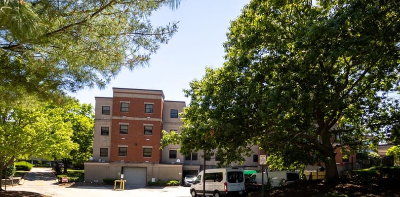 Exterior of Steere House Nursing & Rehabilitation Center surrounded by trees