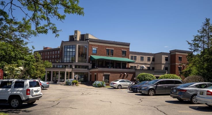 Front view of Steere House Nursing & Rehabilitation Center with parking area