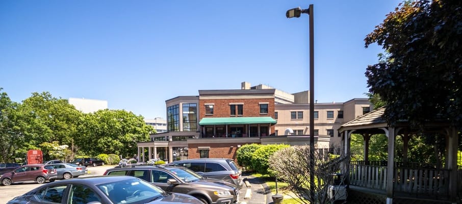 View of the parking lot and exterior of Steere House Nursing & Rehabilitation Center