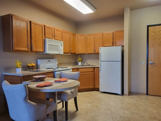 Stylish kitchen with dining table and appliances