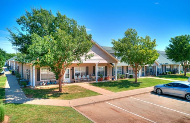 Exterior view of Silver Elm Estates with landscaped pathways and trees