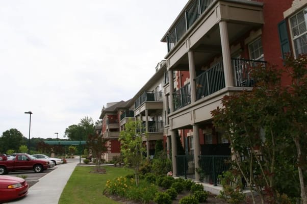 Exterior of Silvercreek Senior Living facility with balconies and garden