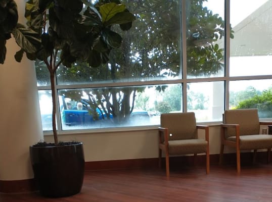 Interior view of the lobby with a large window and seating area.